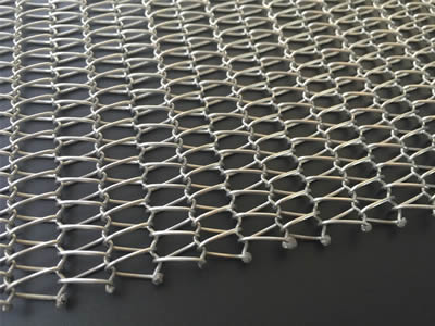 A piece of stainless steel balanced weave belt with welded edge on the black background.