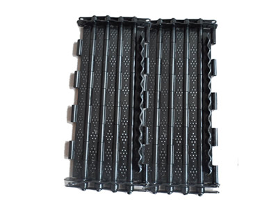 A piece of carbon steel chain plate conveyor belt with several round holes on the plates on the white background.