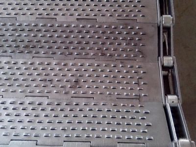 A piece of perforated metal plate conveyor belt with slot holes.