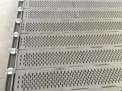 A piece of perforated metal plate conveyor belt with vertical strip holes.
