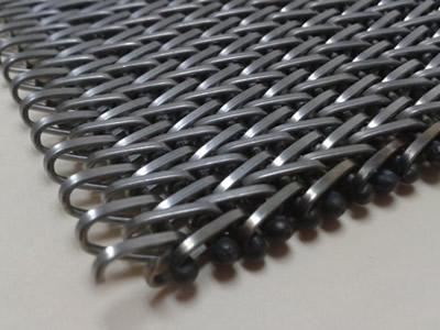 A piece of compound weave oven mesh belt made of flat steel wire.