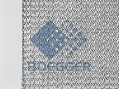 A piece of stainless steel flat rolled oven mesh belt with company logo on the gray background.