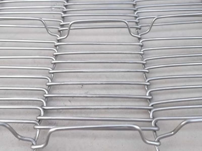 A piece of stainless steel rod network oven mesh belt on the ground.