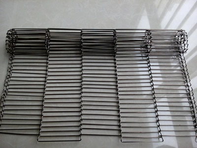 A piece of stainless steel rod network oven mesh belt on the floor.