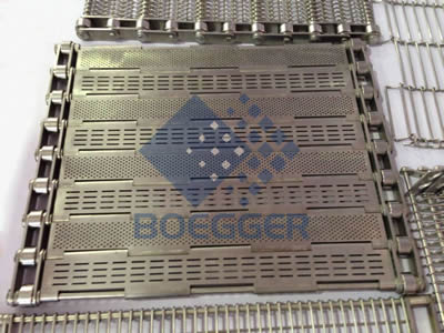 A piece of perforated metal plate belt with horizontal strip holes on the table.